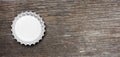 Glass beer bottle cap isolated on wooden background, top view, banner. 3d illustration Royalty Free Stock Photo