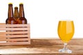 Glass of beer and bottles with no logo on wooden table isolated copy space, glass bottle Royalty Free Stock Photo