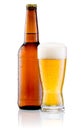 Glass of beer and Brown bottle with drops isolated