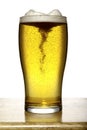 Glass of beer with foam on wood and white Royalty Free Stock Photo