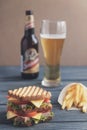 Glass of beer a burger a wooden background Royalty Free Stock Photo
