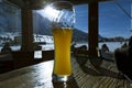 Glass of beer in cafe at ski resort in Italy, Alps Royalty Free Stock Photo