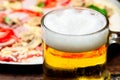 Glass of beer close up on pizza background Royalty Free Stock Photo