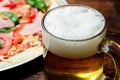 Glass of beer close up on pizza background Royalty Free Stock Photo