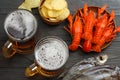 Glass beer with crawfish, dried fish and wheat ears on dark wooden background. Beer brewery concept. Beer background. top view Royalty Free Stock Photo