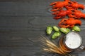 Glass beer with crawfish, hop cones and wheat ears on dark wooden background. Beer brewery concept. Beer background. top view Royalty Free Stock Photo