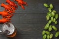 Glass beer with crawfish, hop cones and wheat ears on dark wooden background. Beer brewery concept. Beer background. top view Royalty Free Stock Photo