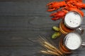 Glass beer with crawfish, hop cones and wheat ears on dark wooden background. Beer brewery concept. Beer background. top view Royalty Free Stock Photo