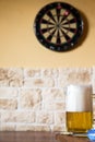 Glass of beer and dartboard Royalty Free Stock Photo