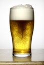 Glass of beer with delicious white foam Royalty Free Stock Photo