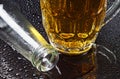 Glass of beer and an empty bottle Royalty Free Stock Photo