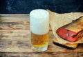 Glass of beer with foam, smoked salmon on paper Royalty Free Stock Photo