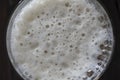 Glass of beer foam on wooden table, top view, close up, macro Royalty Free Stock Photo