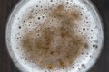 Glass of beer foam on wooden table, top view, close up, macro Royalty Free Stock Photo
