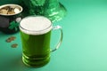 Glass of beer, gold and party hat on green background, space for text. St Patrick`s Day celebration Royalty Free Stock Photo