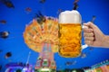 Glass of beer holding in hand at Oktoberfest in Munich Royalty Free Stock Photo