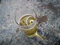 A glass of beer with ice on wood background Royalty Free Stock Photo