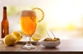 Glass of beer with lemon with appetizer on wooden table Royalty Free Stock Photo