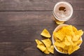 Glass of beer with nachos chips on a wooden background Royalty Free Stock Photo