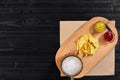 Glass of beer with nachos chips on a wooden background. Royalty Free Stock Photo