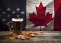 A glass of beer next to a Canadian flag