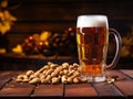 glass of beer with nuts on a wooden table