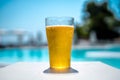 Glass of beer by the pool Royalty Free Stock Photo