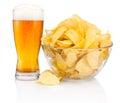 Glass of beer and Potato chips in glass bowl isolated on white