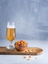 Glass of Beer and pretzel pieces snacks on light background with space for you text Royalty Free Stock Photo