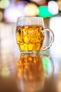 Glass of beer in pub, hand of bartender pouring a large lager beer in tap, the beer taps in a pub Royalty Free Stock Photo