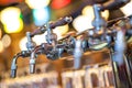 Glass of beer in pub, hand of bartender pouring a large lager beer in tap, the beer taps in a pub.