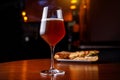 A glass of beer and a sandwich in a bar on a wooden table Royalty Free Stock Photo