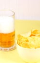 Glass of beer and snack - bowl of chips
