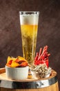 glass of beer with snacks. Dried fish mix on wood plate. dried fish chorizo sausage meat carpaccio Royalty Free Stock Photo