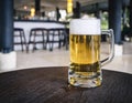 Glass of Beer on table with Blurred Bar counter background Royalty Free Stock Photo