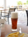 Glass glass of beer on the table in the summer bar Royalty Free Stock Photo