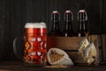 Glass of beer on table with wooden crate full of bottles Royalty Free Stock Photo