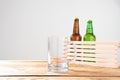 Glass of beer and two bottles on a wooden table . Top view. Selective focus. Mock up. Copy space.Template. Blank.