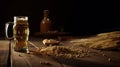 Glass of beer and wheat ears on a wooden table. Dark background. Royalty Free Stock Photo