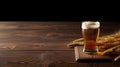 Glass of beer and wheat ears on a wooden table. Dark background. Royalty Free Stock Photo