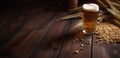 Glass of beer and wheat ears on a wooden table. Dark background. Royalty Free Stock Photo