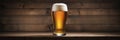 Glass of beer on a wooden background, closeup, isolated