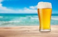 Glass of beer on wooden table on background of sea Royalty Free Stock Photo