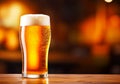 Glass of beer on wooden table. Blurred background with space for text, copyspace, banner