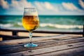 a glass beer glass on a wooden table in the blurred sea background Generative AI Royalty Free Stock Photo
