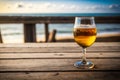 a glass beer glass on a wooden table in the blurred sea background Generative AI Royalty Free Stock Photo