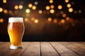 Glass of beer on wooden table over bokeh lights background. A glass of beer on a wooden board and blurred bar background.Free
