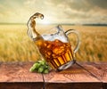 Glass of beer on wooden table with sea on background Royalty Free Stock Photo