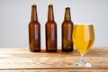 Glass of beer on wooden table, top view. Beer bottles. Selective focus. Mock up. Copy space.Template. Blank.