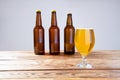 Glass of beer on wooden table, top view. Beer bottles. Selective focus. Mock up. Copy space.Template. Blank.